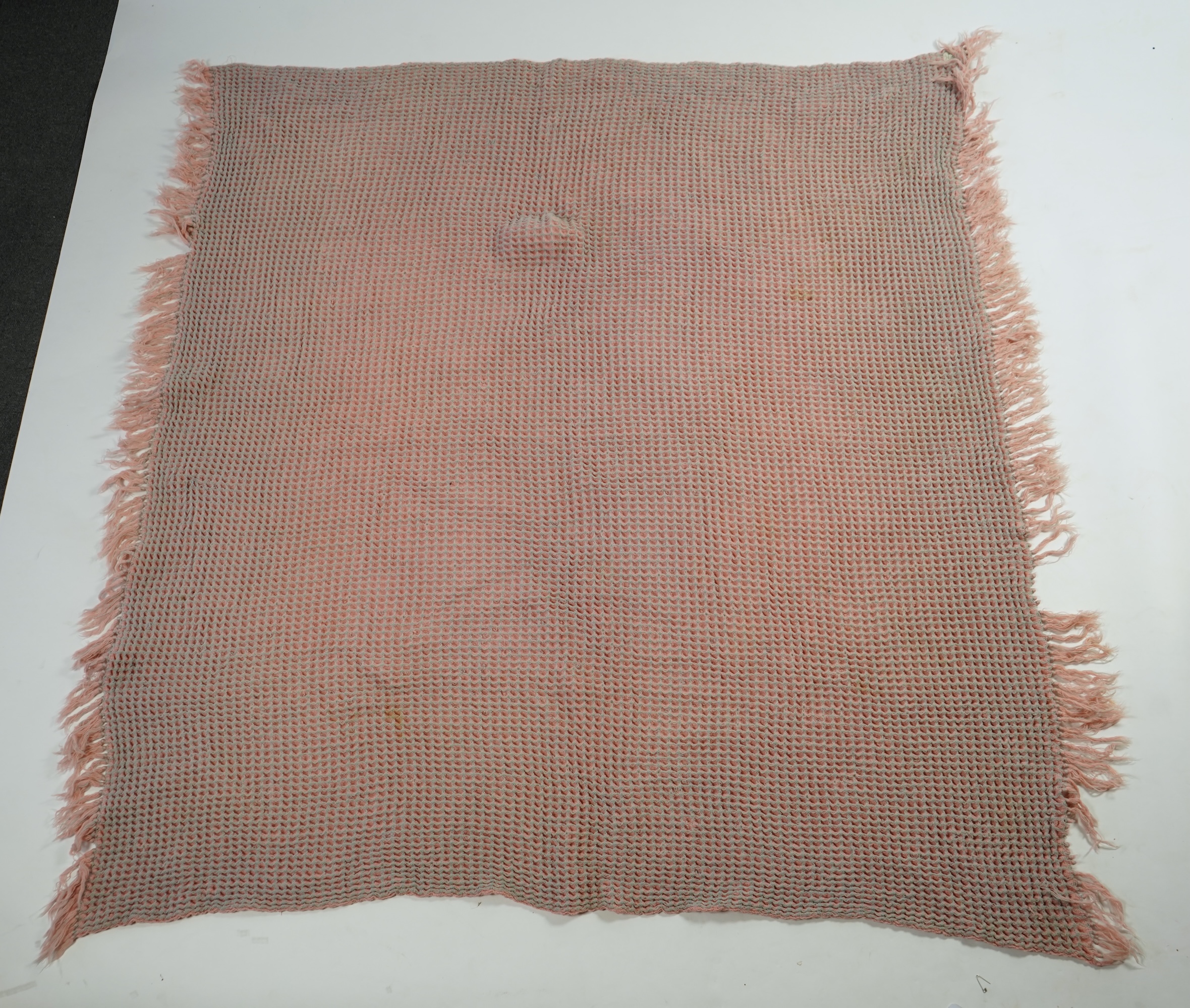 An unusual pink and grey honeycomb woven wool Welsh blanket. 194cm x 176cm. Condition - various threads have pulled and there is a small stain.